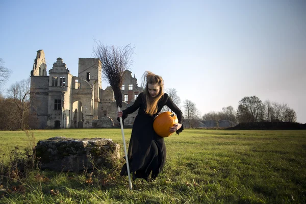 Witch with pale skin take broom — Stock Photo, Image