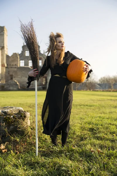 Witch with pale skin hold broom — Stock Photo, Image