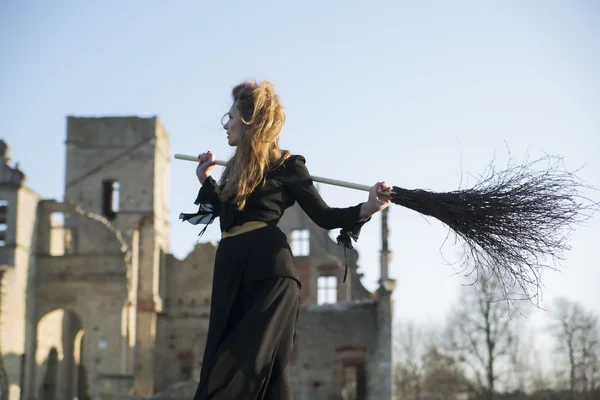 Mujer deressed en bruja traje hold escoba — Foto de Stock