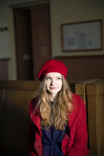 Woman at train station in red costume — Stock Photo, Image