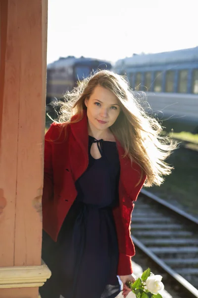 Woman on train station and white rose