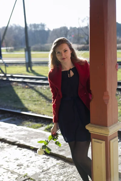 Pillar and woman on station at day — Stock Photo, Image