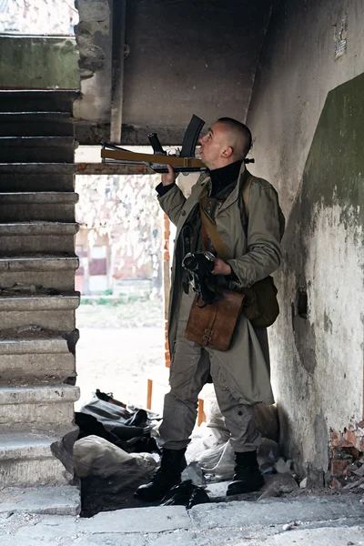 Young man equipped like a hunter in the old building — Stock Photo, Image