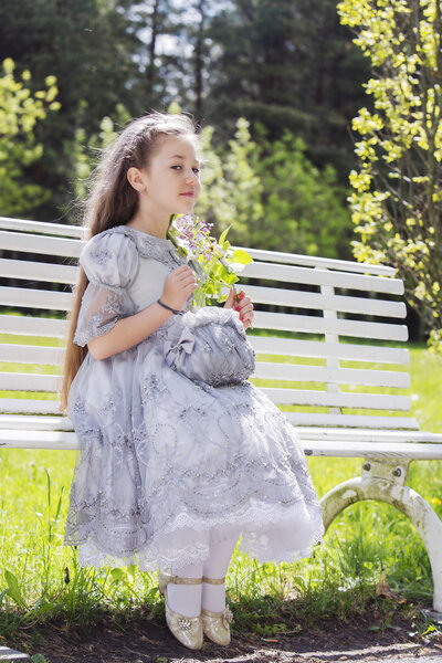 Симпатичный ребенок сидит прилично и хорошо себя ведет.
