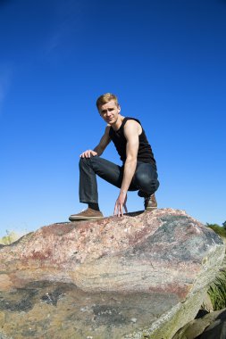 Guy posing at the blue sky background