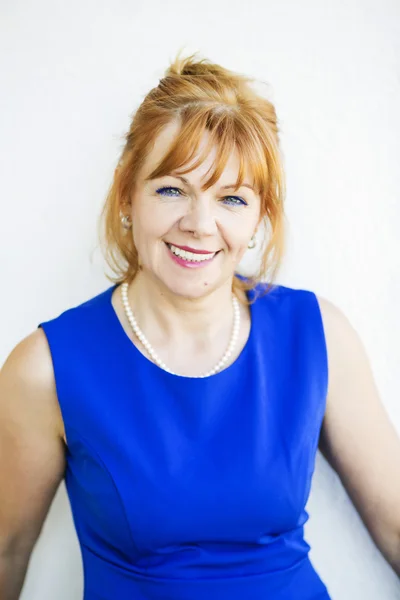 Portrait of smiling woman in blue dress — Stock Photo, Image