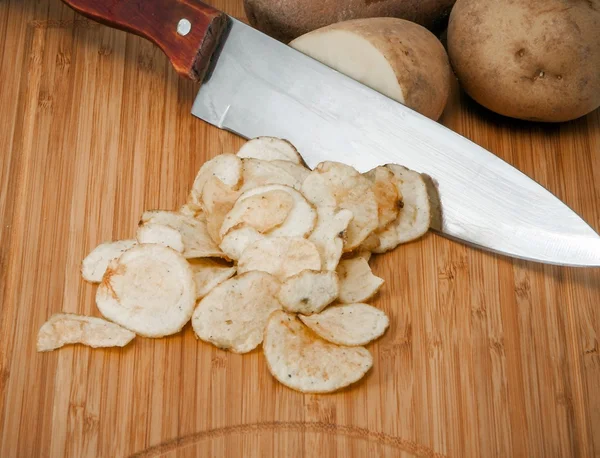 Potatoes with a knife Stock Image