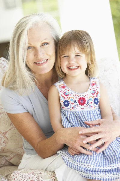 Grandmother And Granddaughter Sitting In Chair — Stock Photo, Image