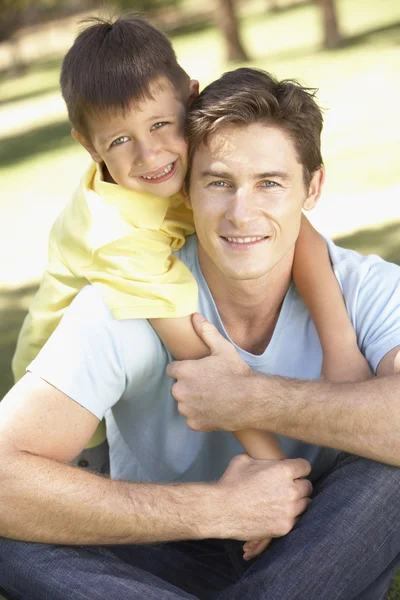 Pai e filho relaxando no parque — Fotografia de Stock