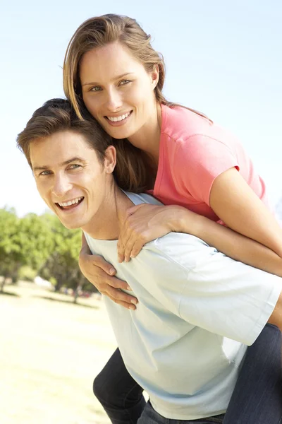 Pareja divirtiéndose Piggyback paseo — Foto de Stock