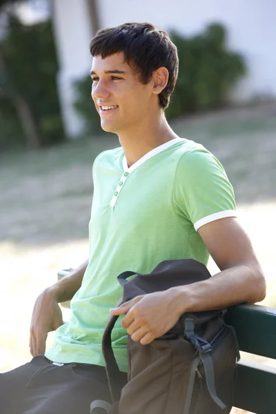 Étudiant assis sur le banc avec sac à dos — Photo