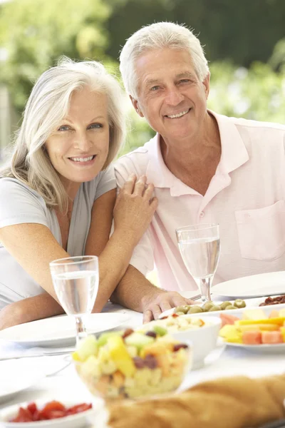 Senior couple enjoying al fresco meal Royalty Free Stock Images