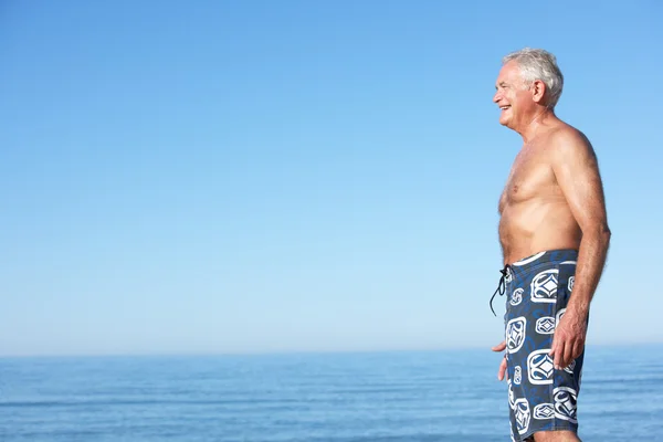 Uomo anziano in piedi sulla spiaggia — Foto Stock
