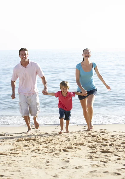 Family Running On Beach Stock Image
