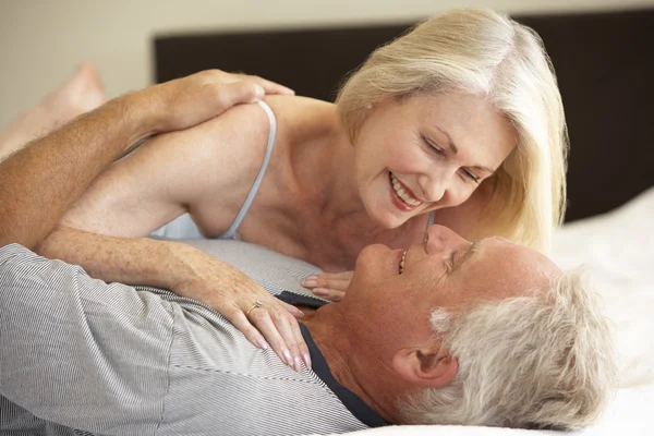 Senior Couple Relaxing On Bed — Stock Photo, Image