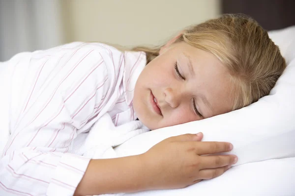 Junges Mädchen schläft im Bett — Stockfoto