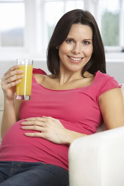 Pregnant Woman Drinking Glass Of Orange Juice Stock Image