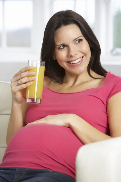 Pregnant Woman Drinking Glass Of Orange Juice Stock Picture