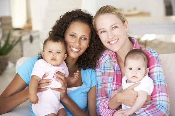 Madres jóvenes en el sofá en casa — Foto de Stock