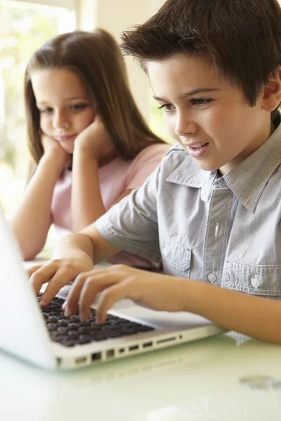 Pojke och flicka med laptop — Stockfoto