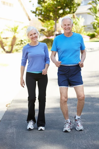 Elderly man and woman jogging — Stock Photo, Image