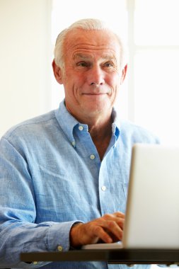 Mature student using computer in class clipart