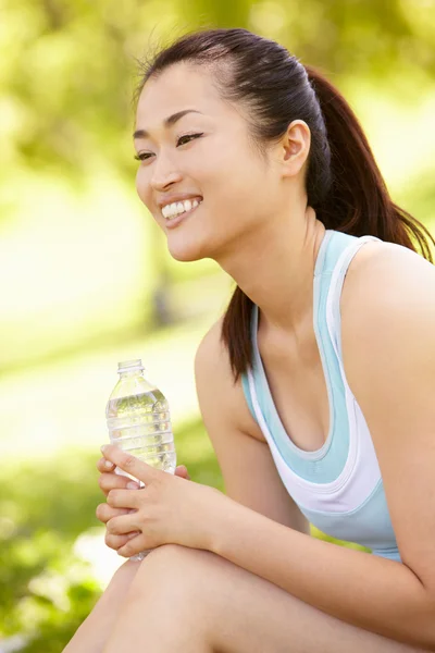 Asian woman resting after exercise — Stock Photo, Image