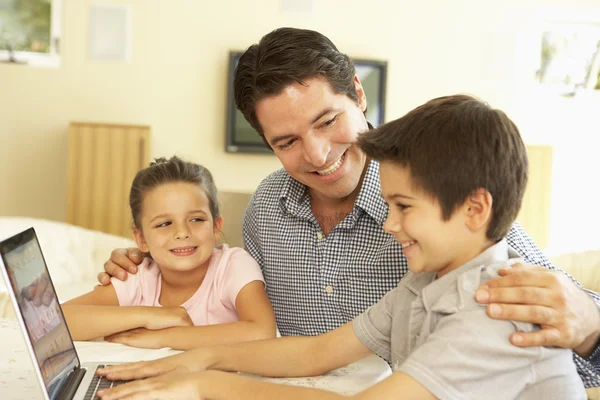 Padre e hijos usando computadora en casa —  Fotos de Stock