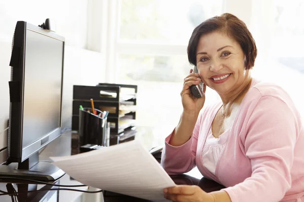 Oudere vrouw die thuis werkt — Stockfoto