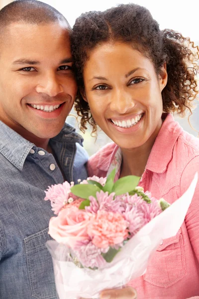 Man giving flowers to woman Royalty Free Stock Images