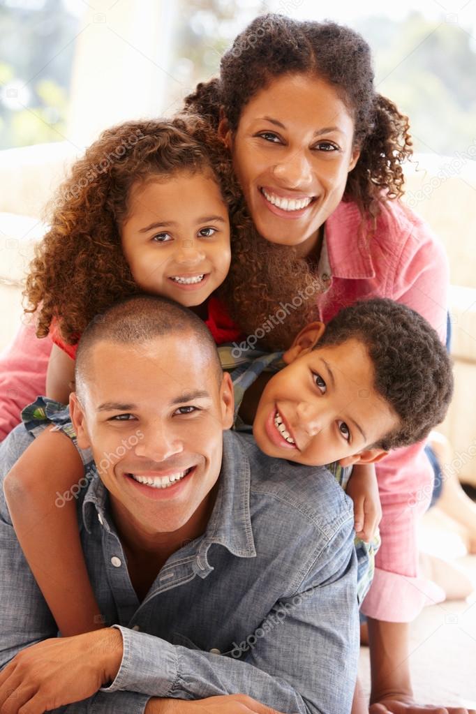Happy Mixed race family smiling to camera at home