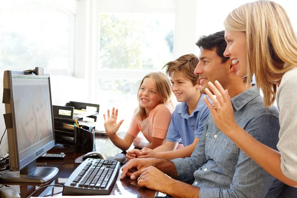 Family using skype in computer — Stockfoto