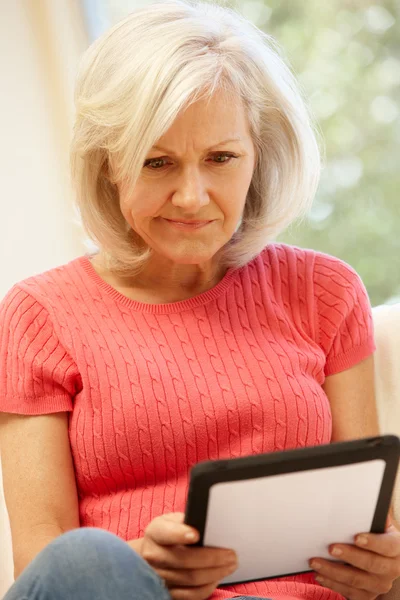 Женщина средних лет с помощью цифрового планшета — стоковое фото