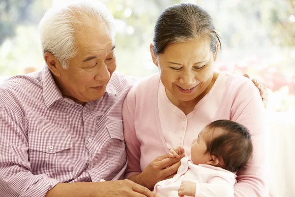 Happy  grandparents holding baby — Stock Photo, Image