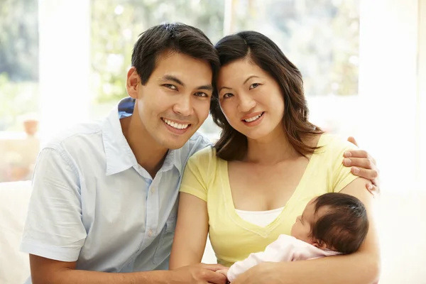 Happy couple holding their baby — Stock fotografie