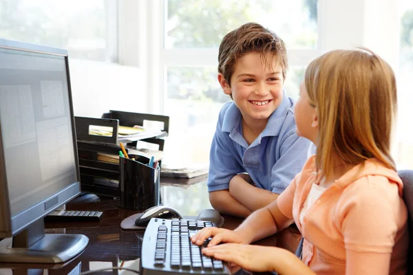 Young boy and girl using computer Stock Image