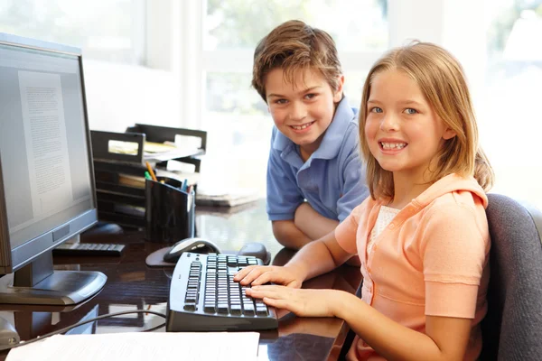 Young boy and girl using computer Stock Photo