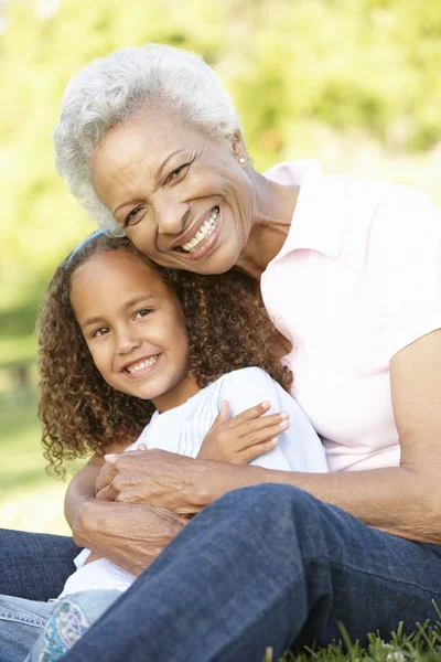 Mormor och barnbarn avkopplande i Park — Stockfoto