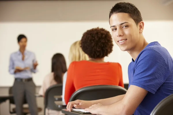 Teenage boy in class smiling to camera — Stock Photo, Image