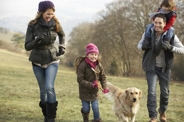 Family and dog on country walk — Stockfoto