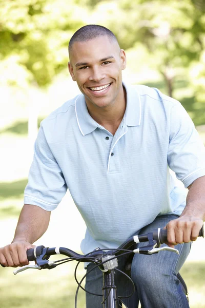 Young Man Cycling In Park Royalty Free Stock Photos