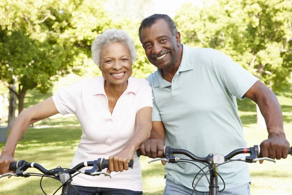 Senior Couple Cycling In Park Stock Picture