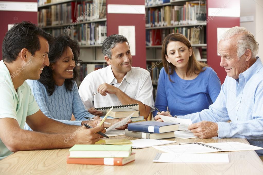 Mature students working in library — Stock Photo © monkeybusiness