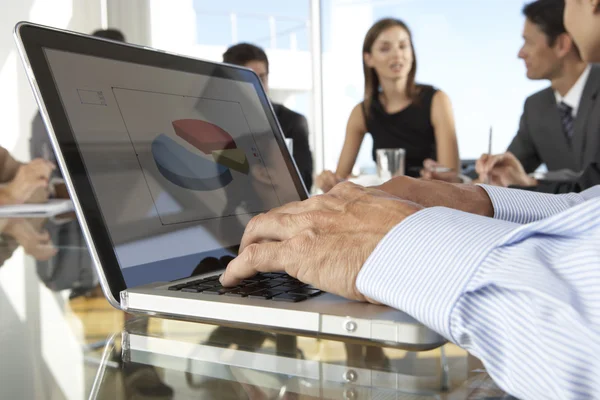 Businessman Using Laptop During Board Meeting — Stockfoto