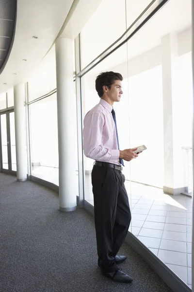 Businessman Using Digital Tablet In Corridor — ストック写真