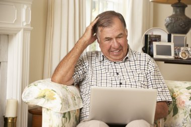 Frustrated Senior Man Using Laptop clipart