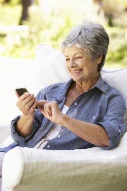 Senior Woman Sending Text Message  clipart
