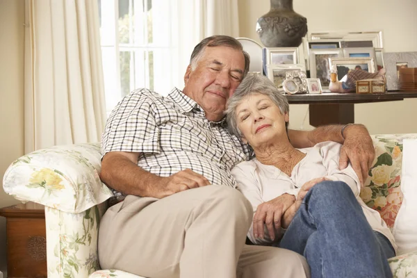 Retired Senior Couple Dozing On Sofa — ストック写真