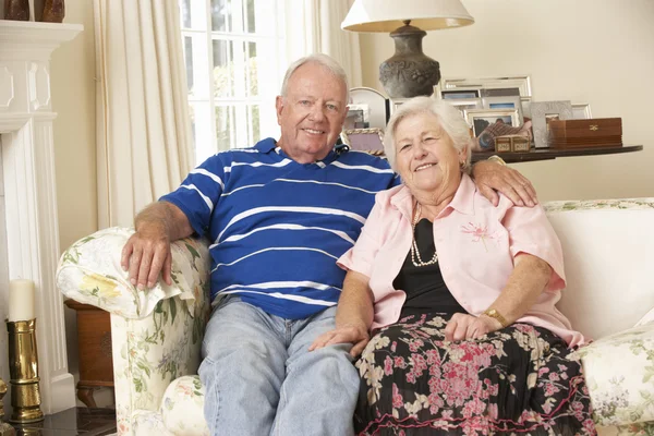 Retired Senior Couple Sitting On Sofa — Stock Photo, Image