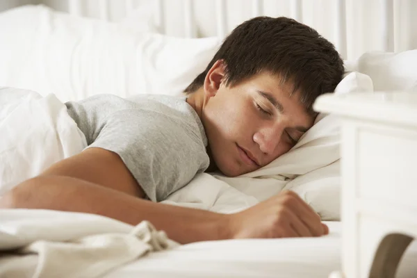 Teenage Boy Asleep In Bed At Home Stock Picture